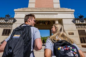 Two students walkingup to Moulton Tower.