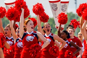 Cheerleaders holding up pom poms.