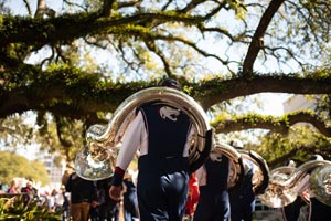 Jaguar Marching Band under downtown trees.