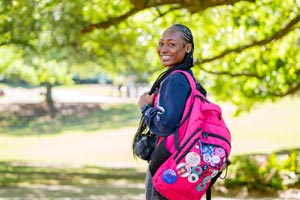 Student with backpack on with buttons on it.