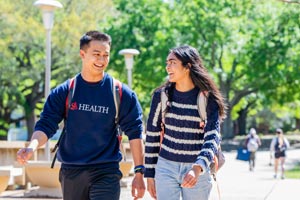 Two biomed students walking on campus.