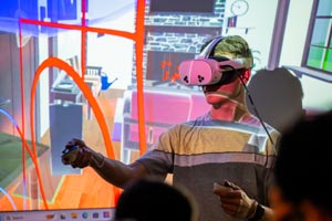 Student working in lab with virtual reality headset.