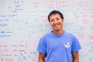 Student in front of whiteboard in Computer Science.