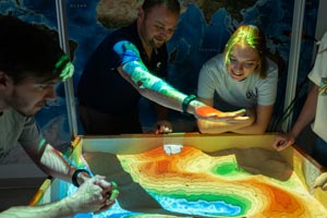 Students looking at electronic map.