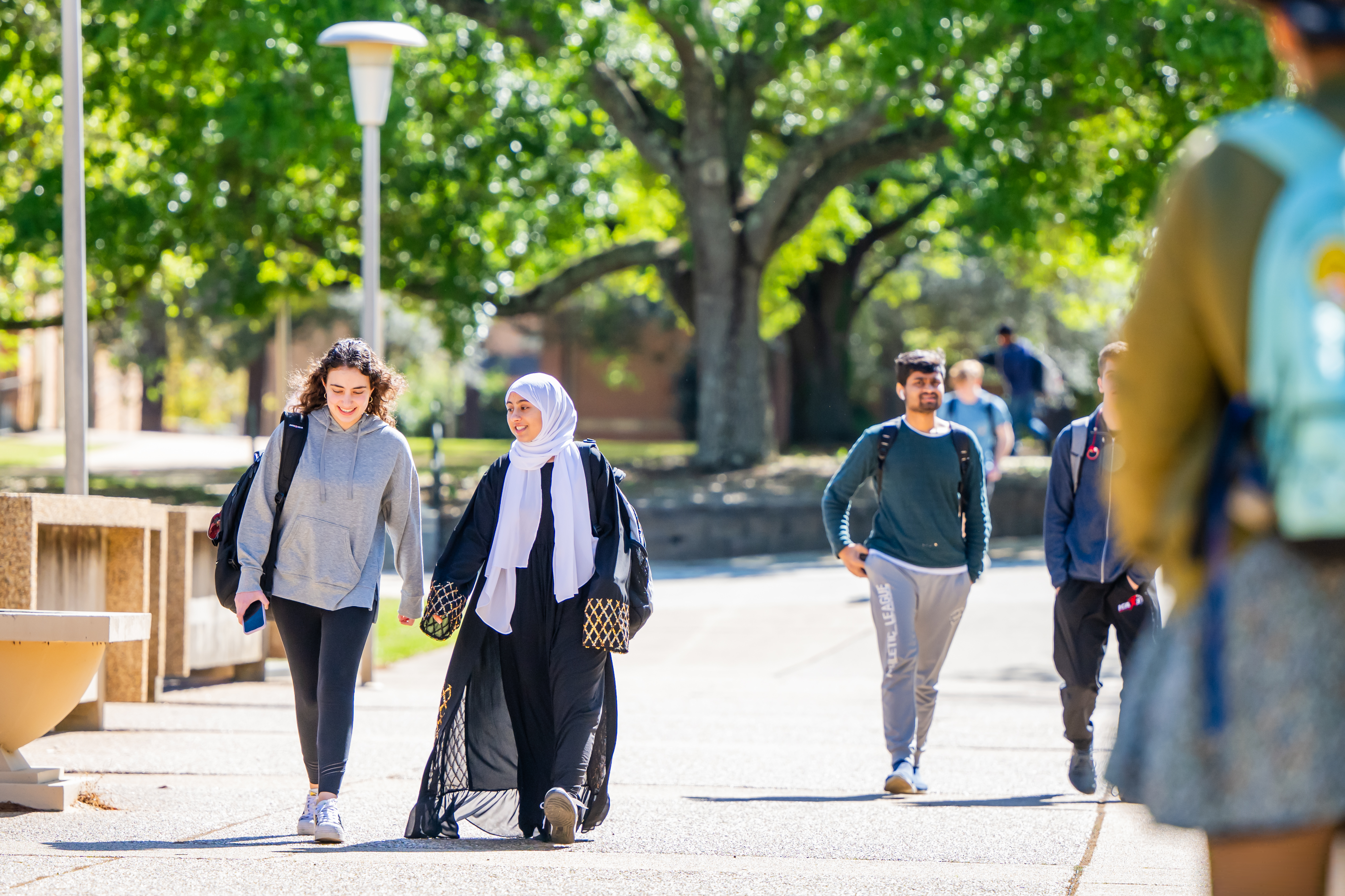Students walking in library breezeway.