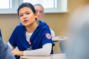 Nursing student in uniform in class.