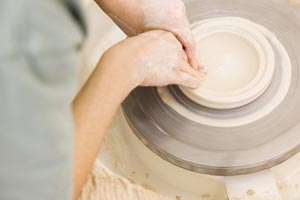 Person making pottery.