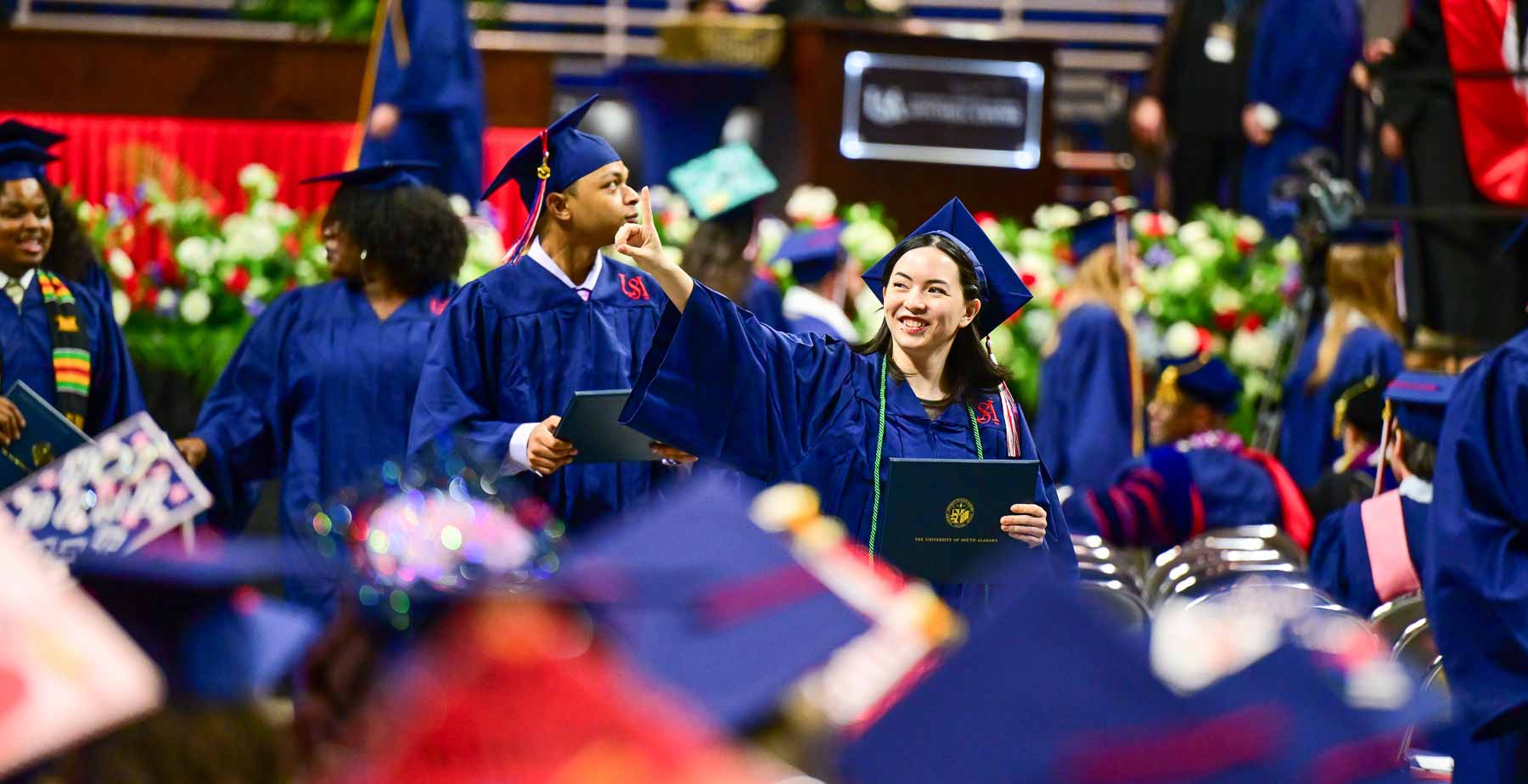 Graduates with diploma covers