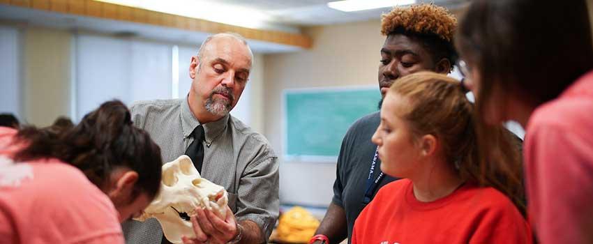 Professor lecturing students about the effects of parenting and pregnancy.