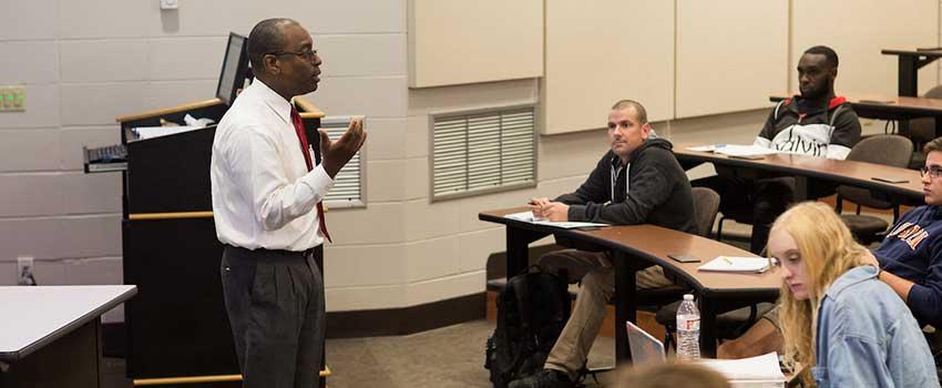 Professor lecturing students about the effects of parenting and pregnancy.