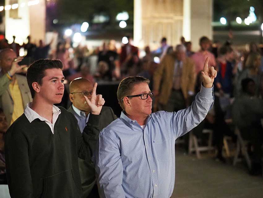 Group holding up J sign.