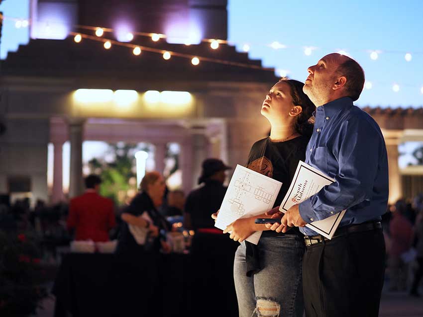 Two people looking up at the Wall of Honor