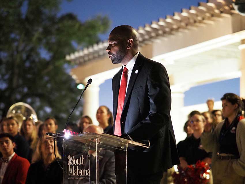 Man speaking at ceremony.