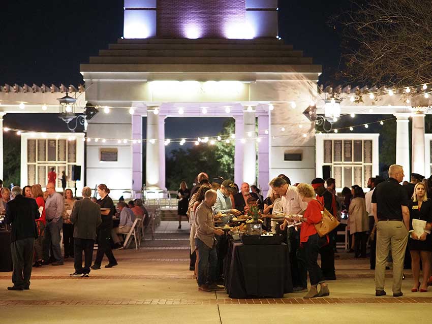 Crowd shot with tables in front of Moulton Tower.