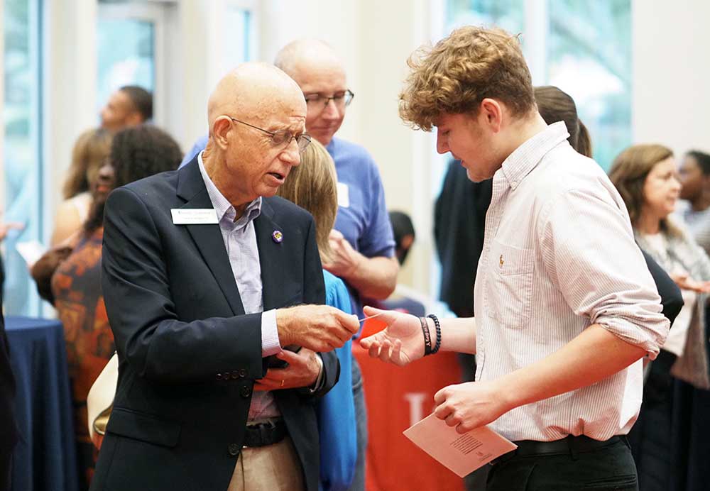 Man handing person business card.