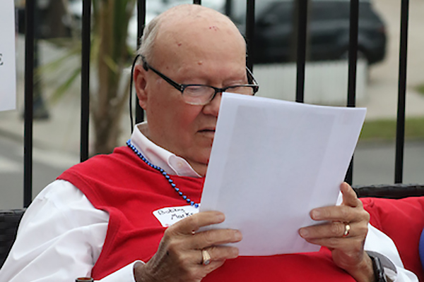 Man reading paper sitting.