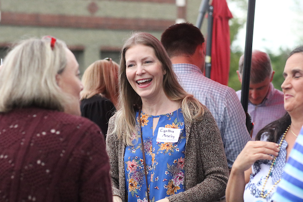 Woman laughing speaking to another person.