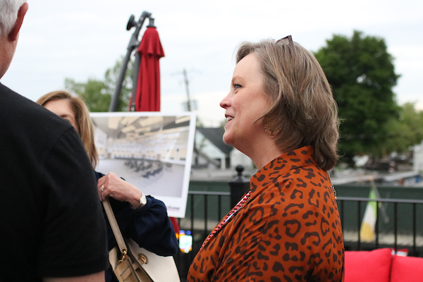 Woman in Jaguar shirt listening.