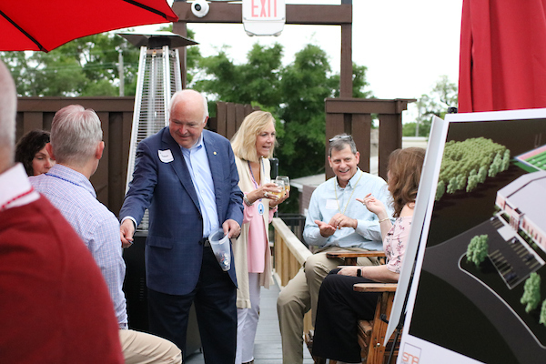 President Bonner shaking hands with alumni.