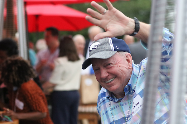 Man in Jags hat waving.