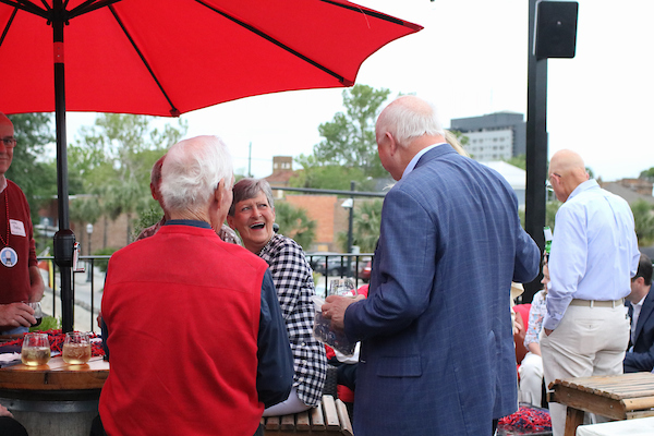 President Bonner speaking to woman who is laughing.