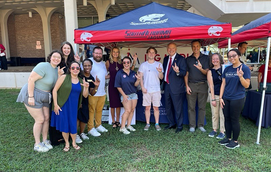 President Bonner standing with group of students at event.