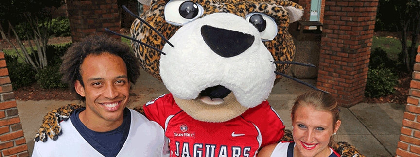 Southpaw with his arms around two cheerleaders.