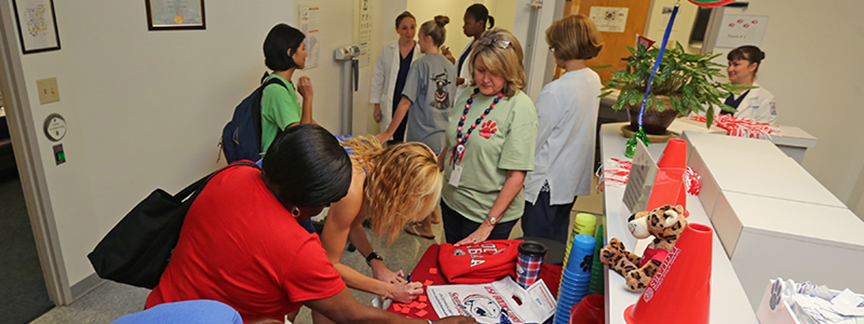 People in the Student Health building with USA cups and shirts.