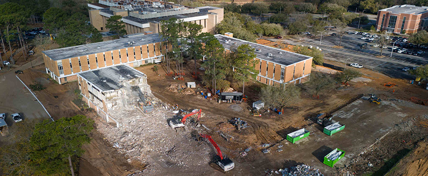 Machines moving rock at building site.