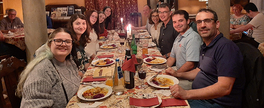 Dr. David Meola sitting at a dinner table with a group.