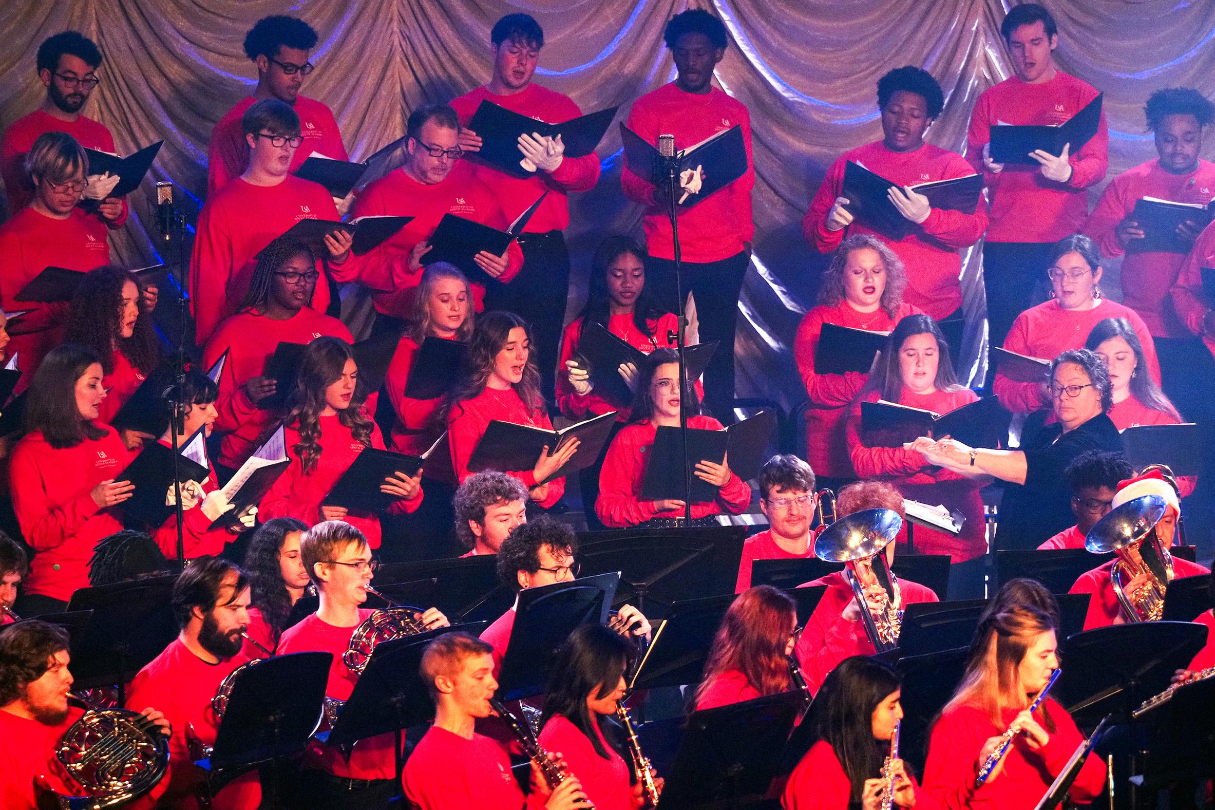 Music group in all red at concert.