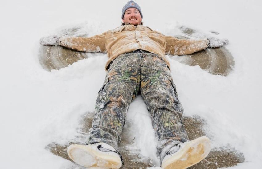 Student making a snow angel.