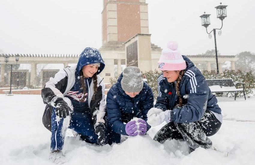 Students making snowballs.