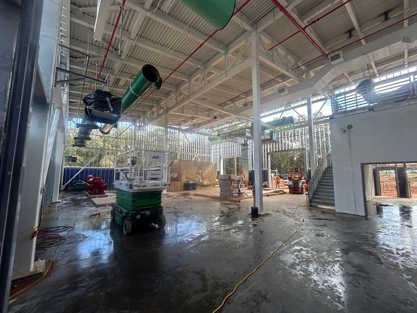 Inside of building showing pipe in ceiling.