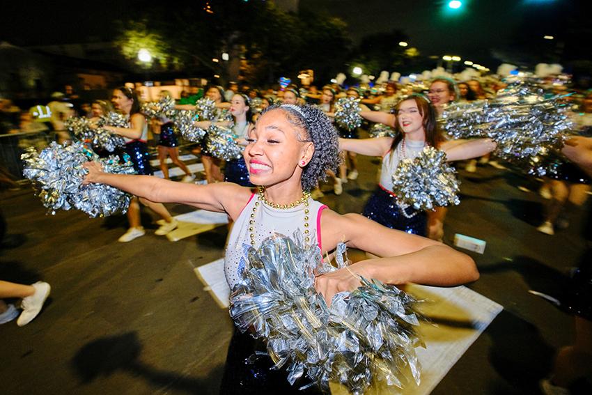 Cheerleader with her pom poms dancing