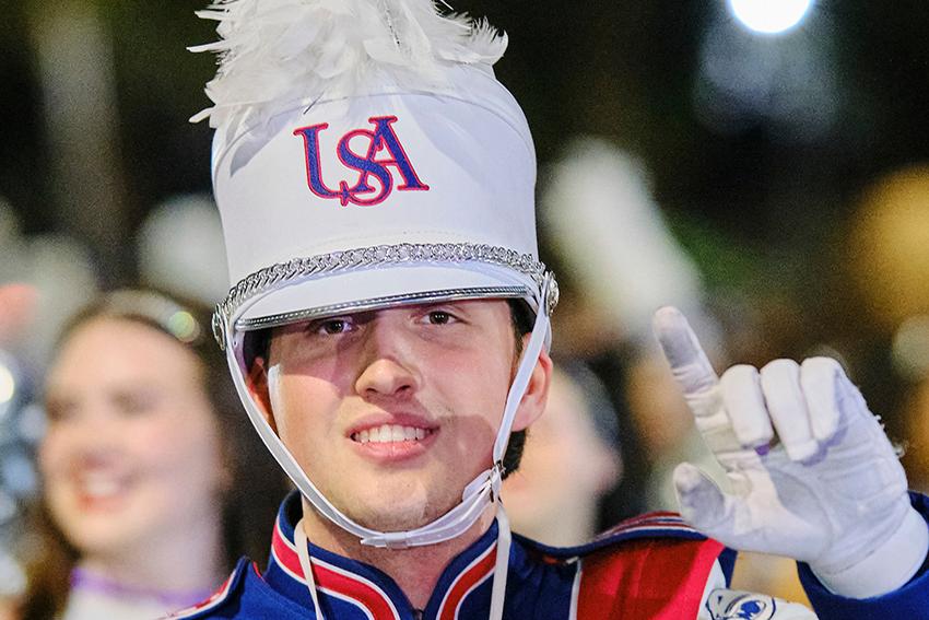 Jaguar Marching Band guy smiling and holding his J's up