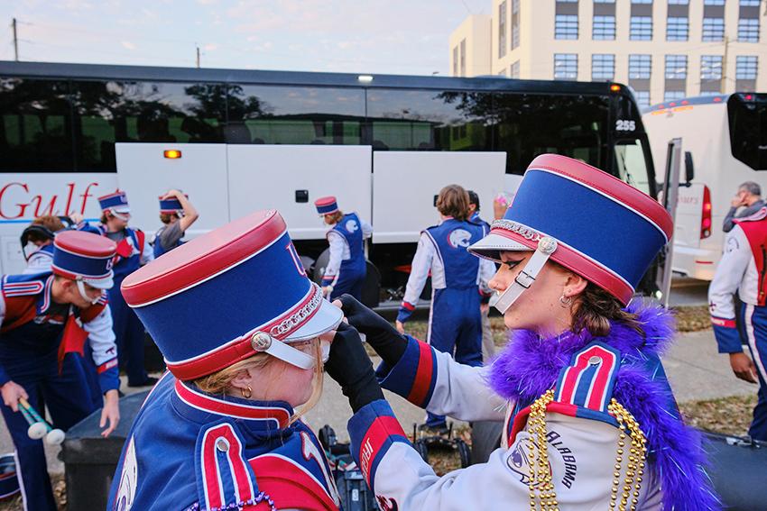 Jaguar Marching Band member fixing her teammate's hat