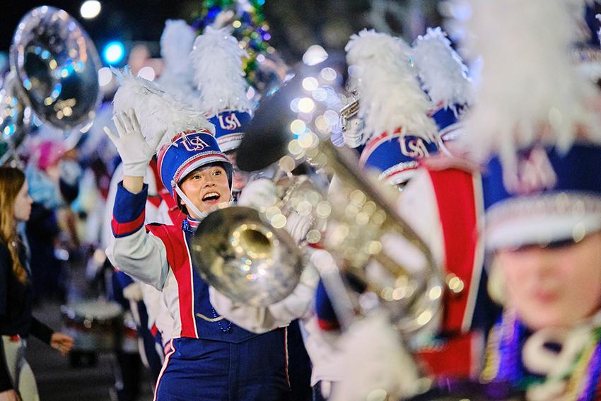 Jaguar Marching Band member waving and smiling