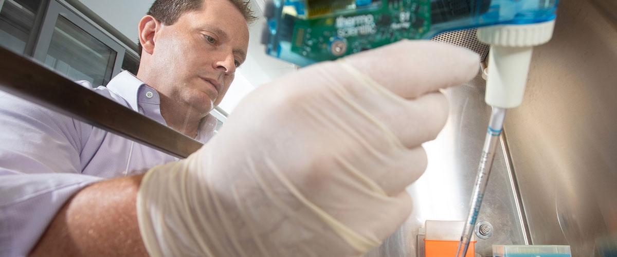 Dr. Borchert in the lab looking at sample.