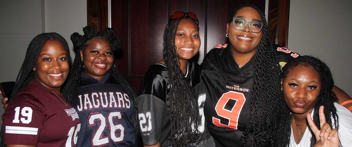 Students in football jerseys.