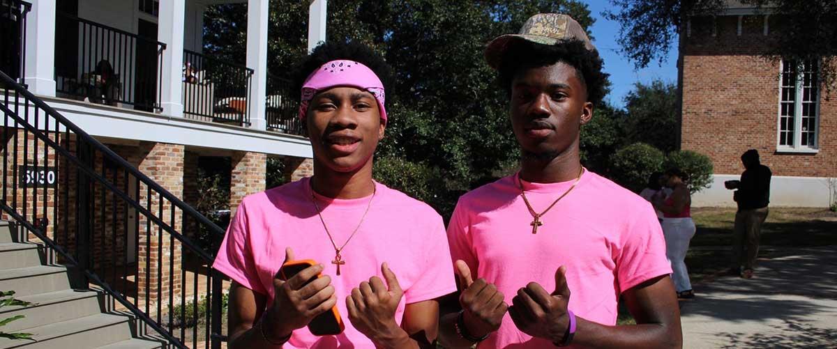 Two USA students in pink shirts.