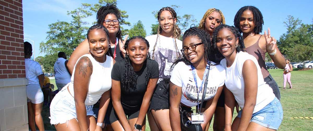 Group of BSU students smiling on campus outside.