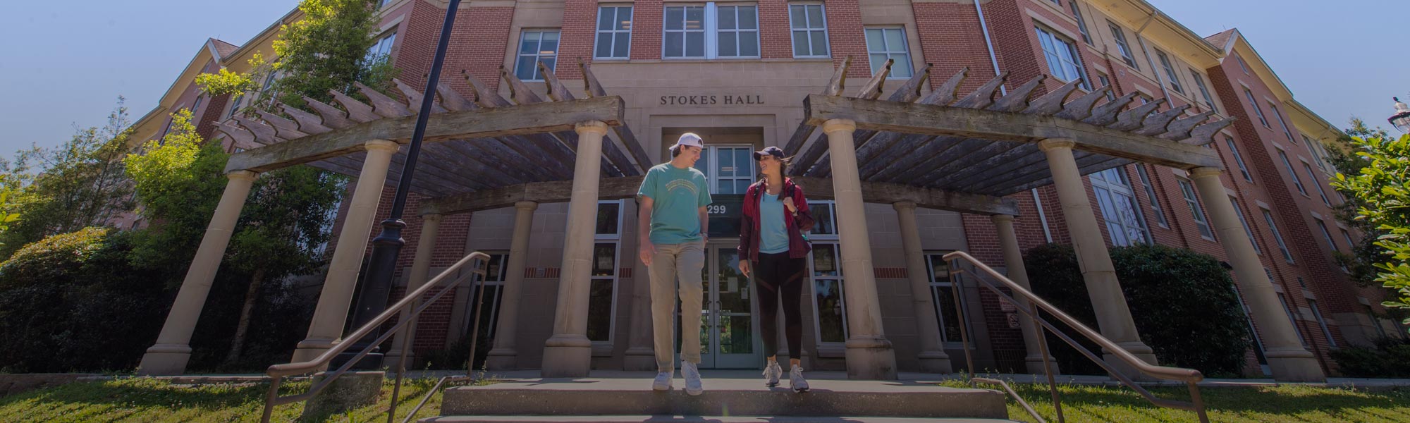 male and female student outside Stokes Hall