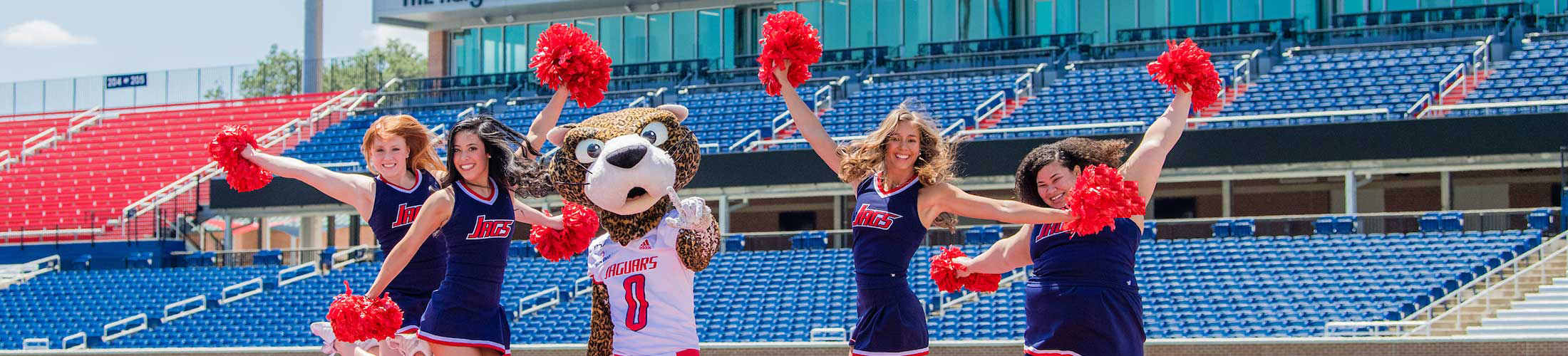 Southpaw with the cheerleaders on the football field.