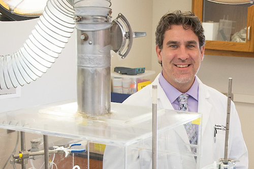 Jon Audia, Ph.D. smiling in the lab