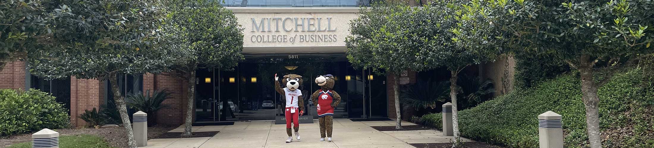Southpaw and Ms Pawla outside of the Mitchell College of Business.