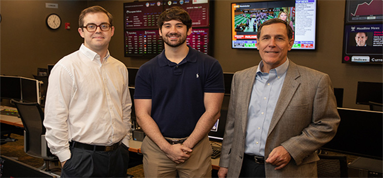 Jacob Corbett, left, and Taylor Shepherd, center, were two of six Mitchell College of Business students on a team that won the 2018 University Portfolio Challenge. Dr. Reid Cummings, director of USA’s Center for Real Estate and Economic Development, and the team’s mentor, right, taught the Finance 446 class each of the students took.