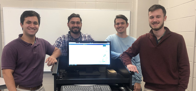 The team of four Mitchell College of Business finance students: Justin Abalos, Thomas Alford, Micah Jordan, and Garrison McGraw