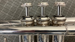 Pictured up close are the three piston valves of a Bach B-flat trumpet.