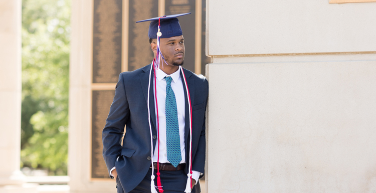 Student in graduation cap and suit.